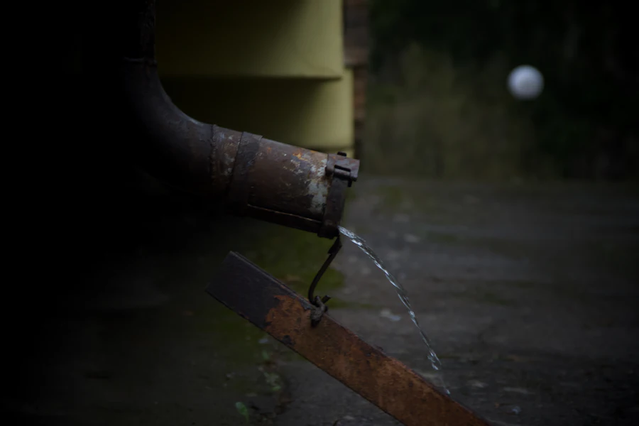 Water dripping from an aging metal downspout